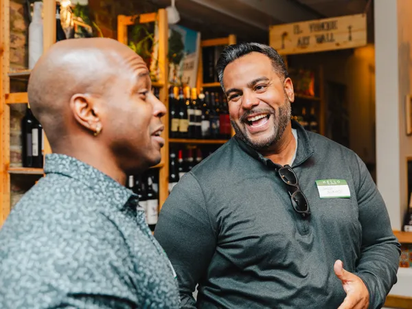 Guests smiling and connecting at a Colado Latino Network event in Baltimore