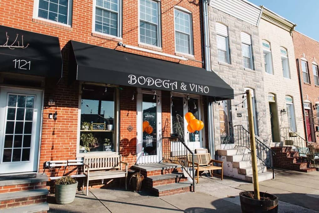 The Bodega and Vino awning in Locust Point, Baltimore, MD, lit with string lights and orange balloons for the first Colado Latino Network gathering