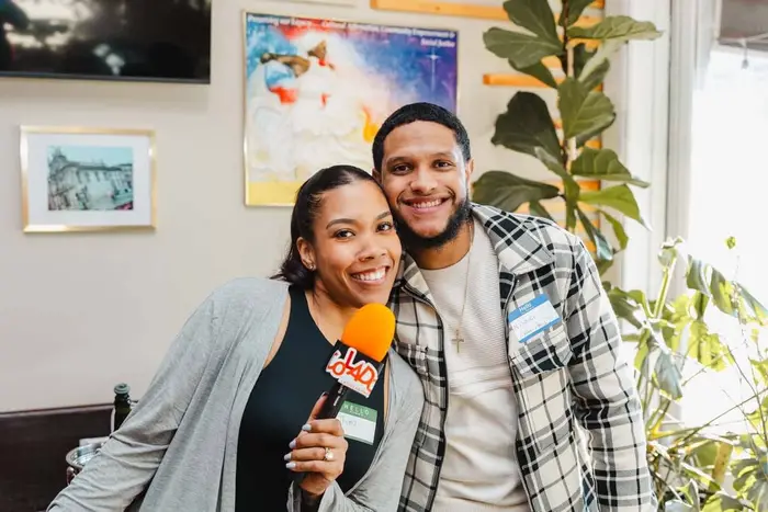 Two guests smiling with the orange Colado microphone at Bodega and Vino