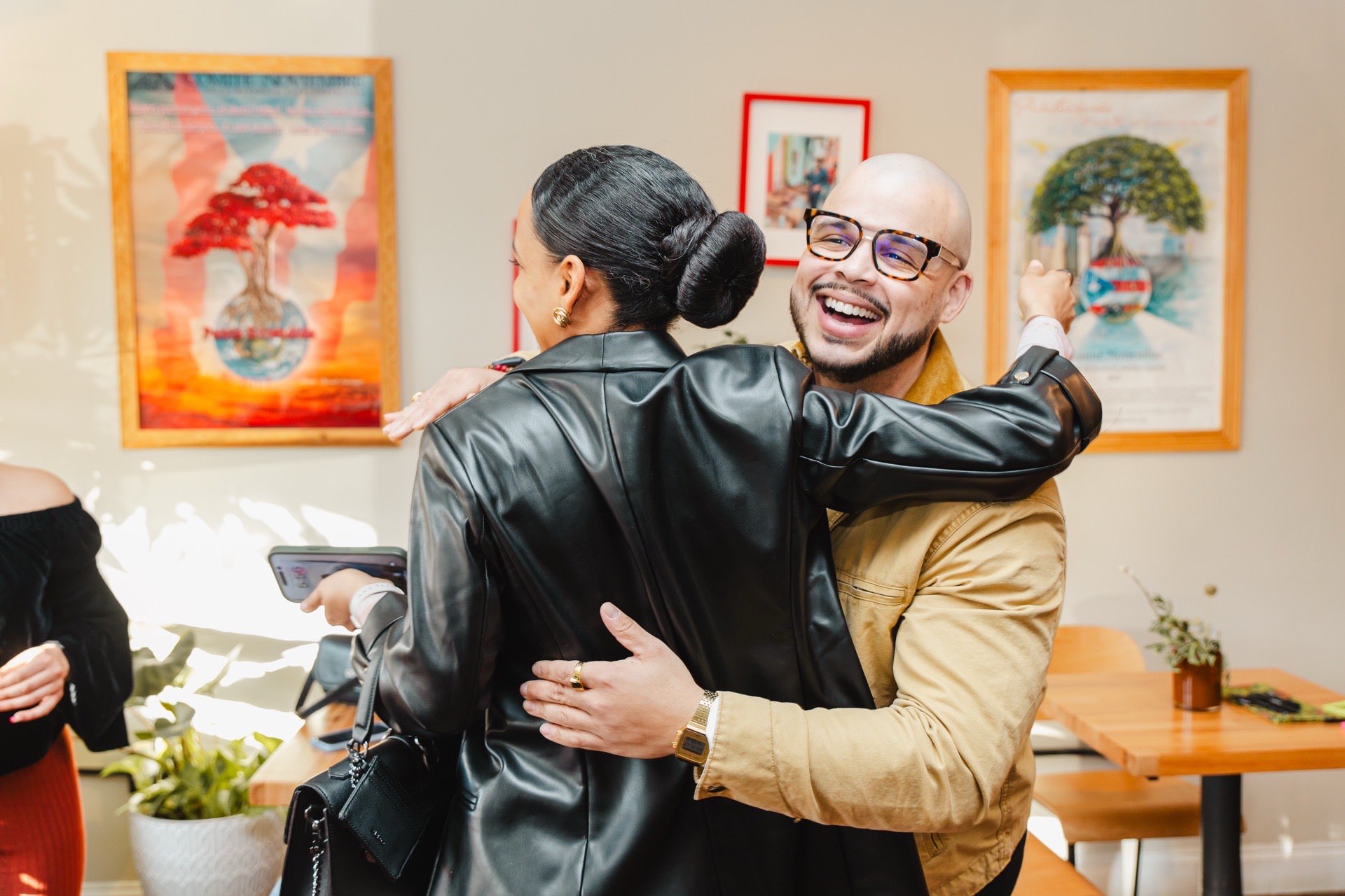 Guests hugging hello at Colado Latino Network's sold-out first event at Bodega and Vino in Locust Point, Baltimore