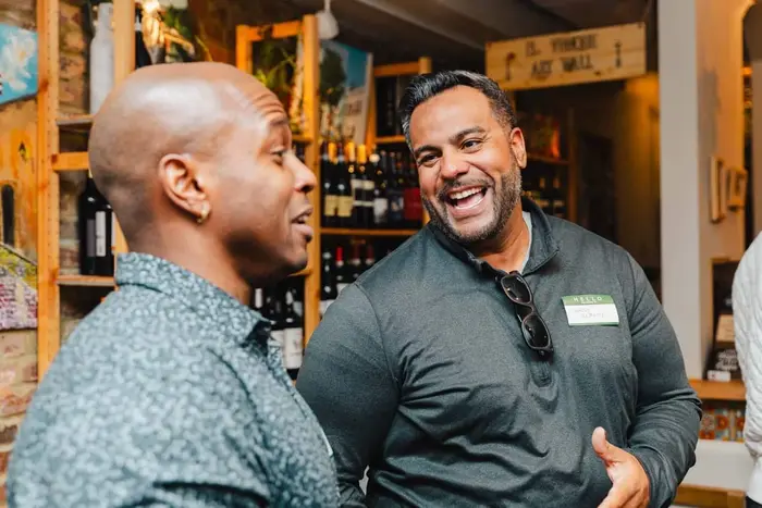 Two men laughing together at the first Colado gathering