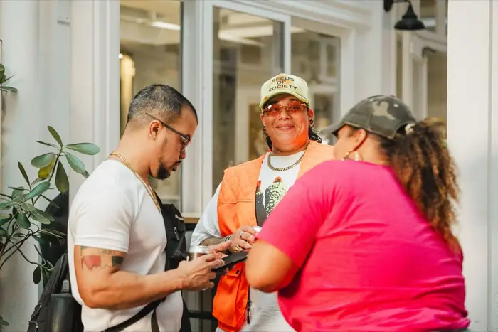 Guests arriving and greeting each other at the Colado Latino Network event at Stem & Vine in downtown Baltimore
