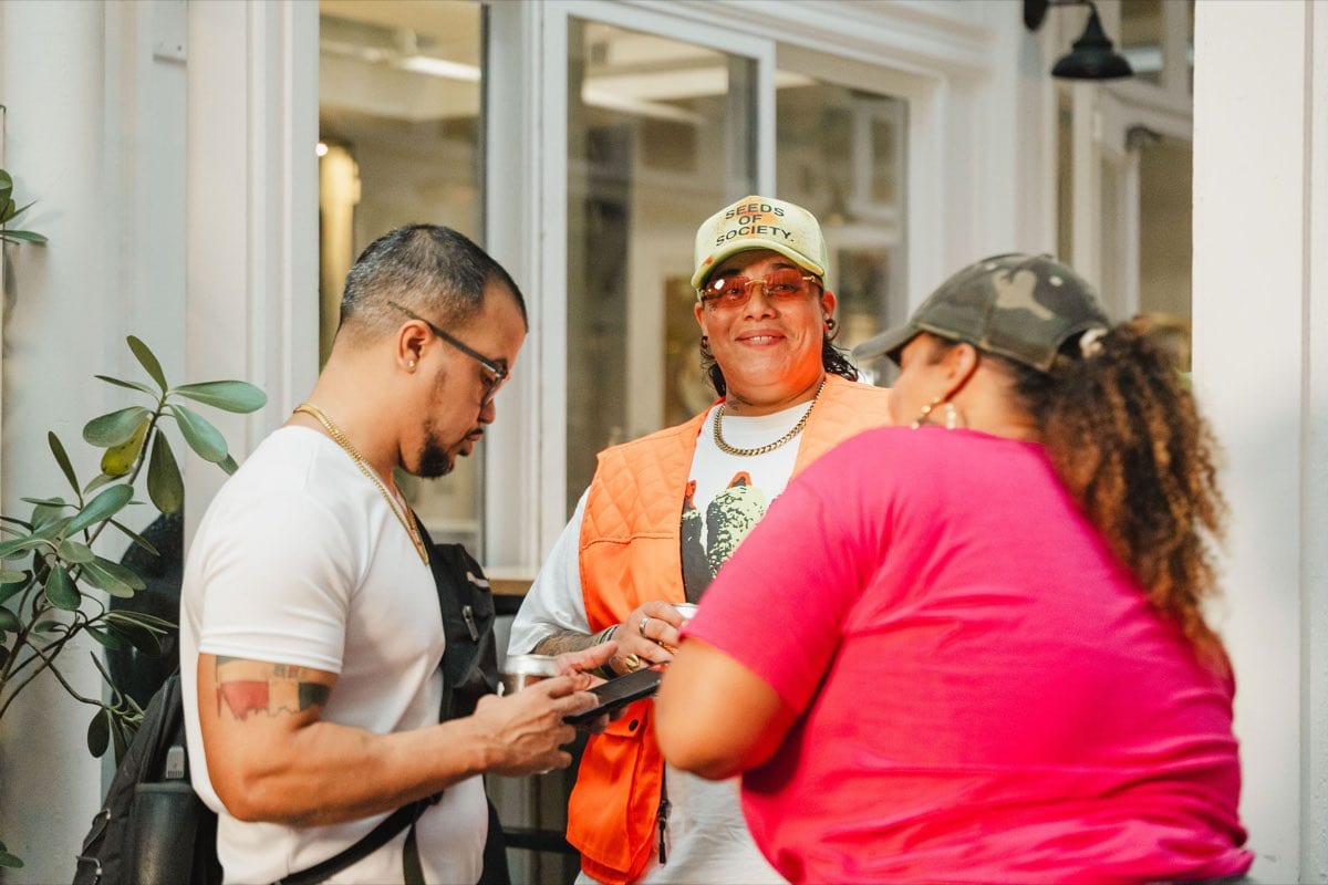 Guests arriving and greeting each other at the Colado Latino Network event at Stem & Vine in downtown Baltimore