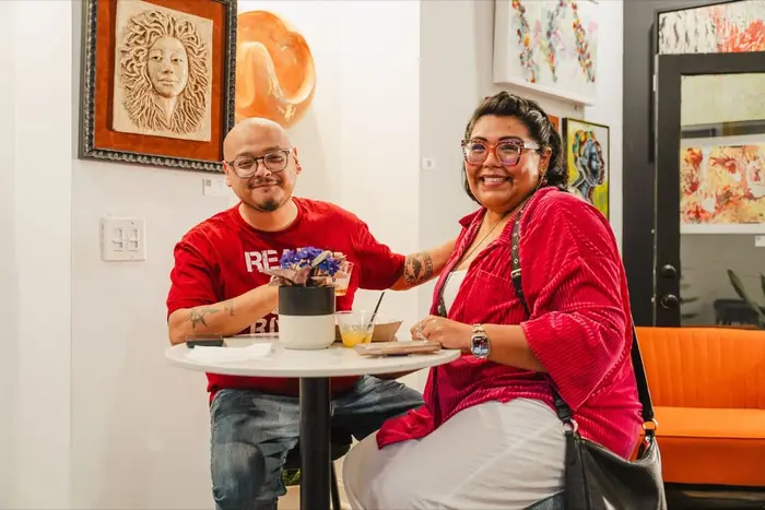 Two guests laughing at a table at Stem & Vine