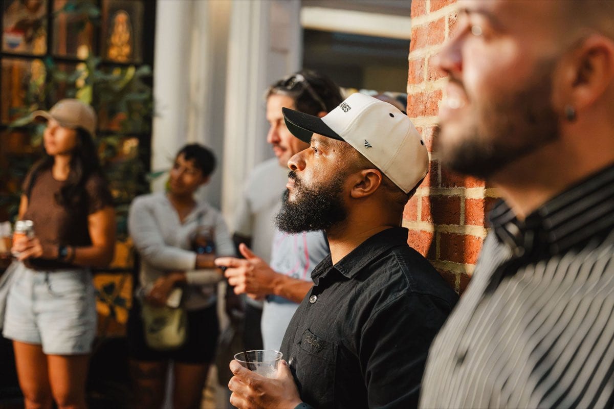 Guests listening together during the Colado Latino Network event at Stem & Vine in downtown Baltimore