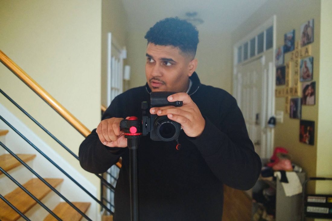 A Colado Latino Network team member setting up a camera during a content shoot in Baltimore, MD